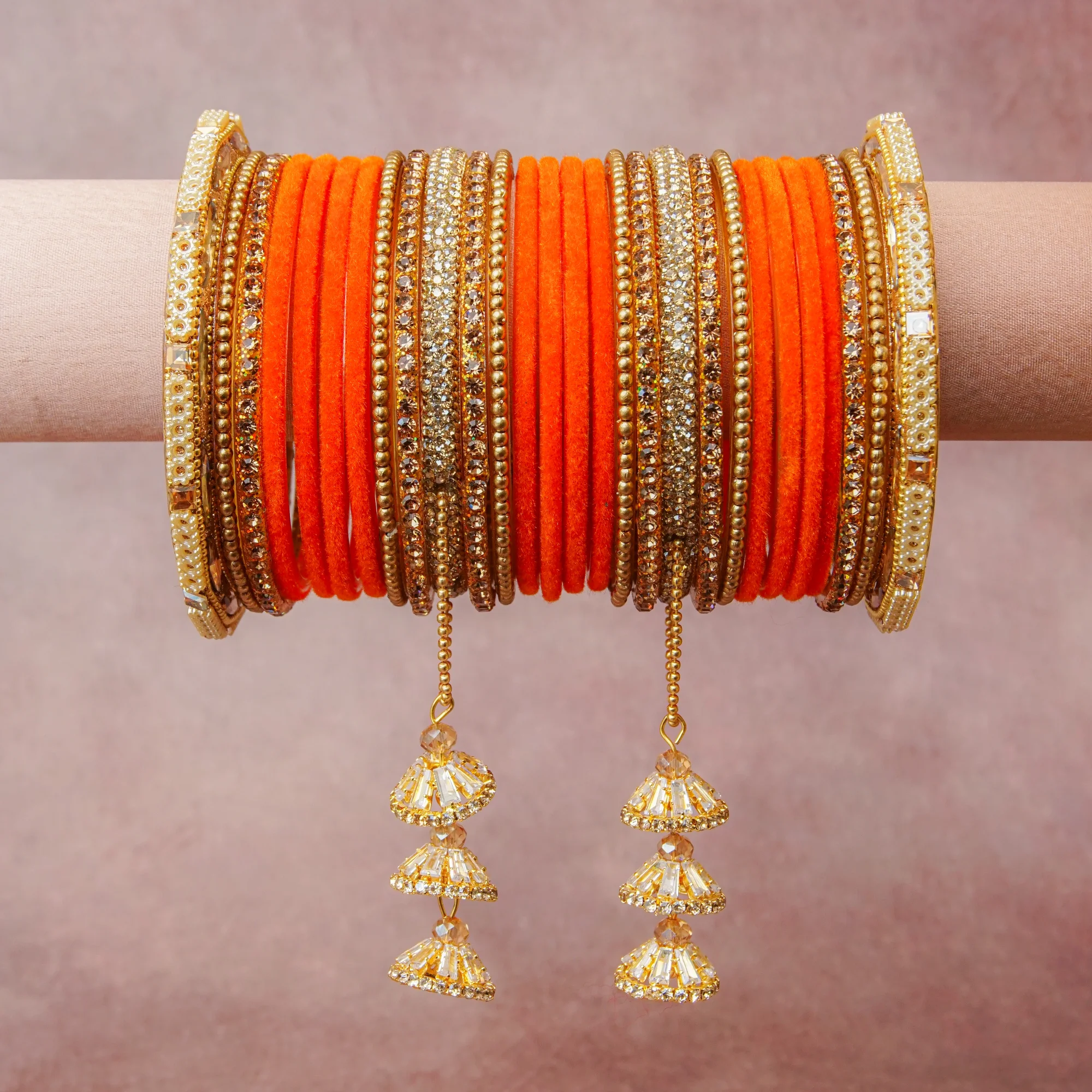 A grounding Orange forms the heart of the set, while touches of Gold, Clear, Cream add charm.

A thoughtful composition of Velvet, Gold-toned metal, Rhinestones, Pearl beads, designed to feel complete without being heavy.
Each element layers seamlessly, creating a look that is refined, wearable and quietly striking.